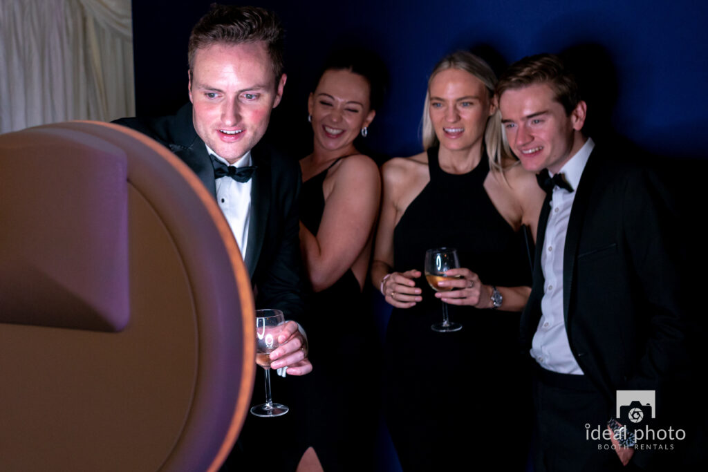 Guest using an interactive photo booth at an evening gala