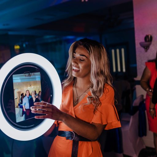 Pretty young lady holding the Roamer at an event while guests pose for photos to be taken