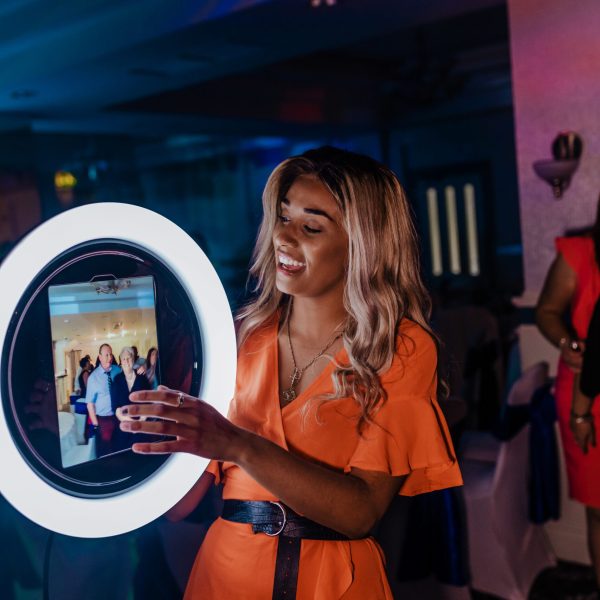 Pretty young lady holding the Roamer at an event while guests pose for photos to be taken