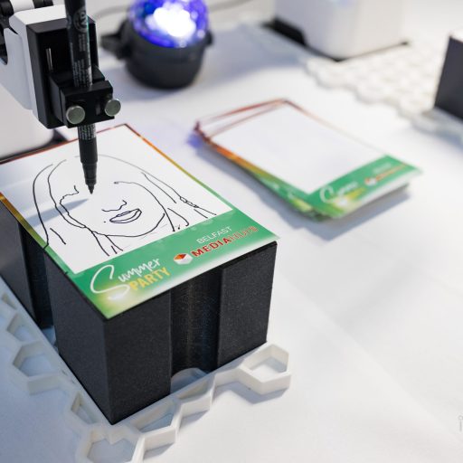 The Sketch Bot doing its thing at a party and sketching guests faces
