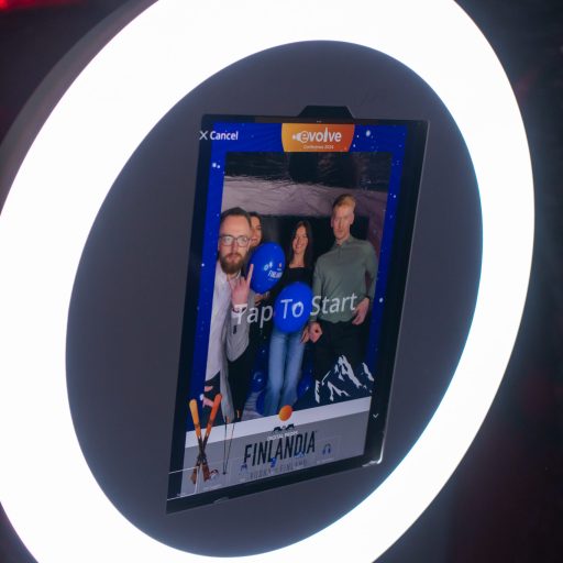 A photo on the Mobibooth Aura, of ladies and gents at a corporate event posing for photos in the bubble dome. Tap to start