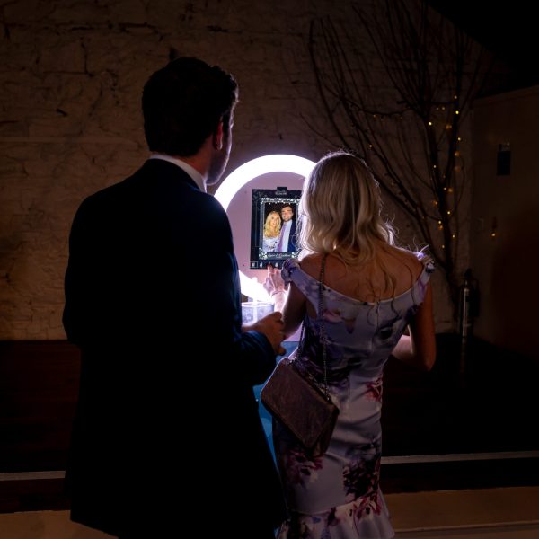 Wedding guests getting ready to use the Mobi Aura booth and have their photos taken